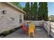 Charming patio with a colorful metal table set and lush greenery backdrop at 6711 Bridgefield Way, Indianapolis, IN 46254