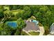 Aerial view of home with tennis court, pool and putting green at 7016 Royal Oakland Way, Indianapolis, IN 46236