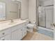 Bright bathroom showcasing a white vanity, toilet, glass shower, and neutral tiling at 7016 Royal Oakland Way, Indianapolis, IN 46236
