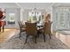 Formal dining room with seating for six, hardwood floors and decorative rug at 7016 Royal Oakland Way, Indianapolis, IN 46236