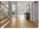 Entryway with hardwood floors, staircase, and view of the dining room at 7016 Royal Oakland Way, Indianapolis, IN 46236