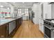 Well-lit kitchen with stainless steel appliances, marble counters, and custom cabinetry at 7016 Royal Oakland Way, Indianapolis, IN 46236