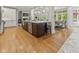 Spacious kitchen features dark wood island, stainless steel appliances, and hardwood floors at 7016 Royal Oakland Way, Indianapolis, IN 46236