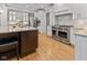Bright kitchen with stainless steel range, granite countertops, and light colored cabinets at 7016 Royal Oakland Way, Indianapolis, IN 46236
