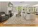 Bright and airy living room with hardwood floors, a fireplace, and large windows at 7016 Royal Oakland Way, Indianapolis, IN 46236