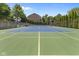Exterior view of a home tennis court surrounded by mature landscaping at 7016 Royal Oakland Way, Indianapolis, IN 46236