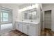 Bright bathroom with double sink vanity, quartz countertops and view of the walk-in closet at 7248 Covington St, Lebanon, IN 46052