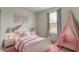 Charming bedroom with pink decor, including a teepee, bed linens, and decorative artwork at 7248 Covington St, Lebanon, IN 46052