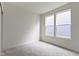 An empty bedroom featuring neutral carpeting and two windows providing natural light at 7248 Covington St, Lebanon, IN 46052