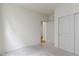 Bright bedroom with neutral carpet, white walls, closet, and paneled door at 7248 Covington St, Lebanon, IN 46052
