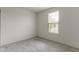 Neutral bedroom features gray carpet, white walls, and a single window for natural light at 7248 Covington St, Lebanon, IN 46052