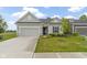 Charming single-story home with gray siding, well-manicured lawn, and attached two-car garage at 7248 Covington St, Lebanon, IN 46052
