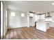 Spacious kitchen with white cabinetry, stainless steel appliances, center island, and hardwood flooring at 7248 Covington St, Lebanon, IN 46052