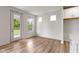 Open living space with hardwood floors, a door to the outside, and several windows at 7248 Covington St, Lebanon, IN 46052