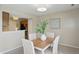 Bright dining room featuring a wood table, four chairs, and modern lighting at 7510 Harbour, Indianapolis, IN 46240