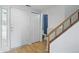 Bright entryway featuring modern door, wood-look floors, and staircase at 7510 Harbour, Indianapolis, IN 46240