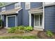 Inviting townhouse with a blue exterior, well-kept landscaping, and attached garage at 7510 Harbour, Indianapolis, IN 46240