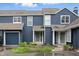 Charming blue townhome exterior featuring well-manicured landscaping and attached garage at 7510 Harbour, Indianapolis, IN 46240