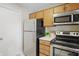 Cozy kitchen featuring stainless steel appliances and wooden cabinetry at 7510 Harbour, Indianapolis, IN 46240
