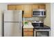 Bright kitchen featuring stainless steel appliances and wooden cabinetry at 7510 Harbour, Indianapolis, IN 46240