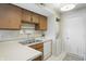 Efficient kitchen features stainless steel sink, white dishwasher, and washer/dryer hookups at 7510 Harbour, Indianapolis, IN 46240