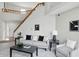 Spacious living area with staircase, modern furniture, and neutral decor at 7510 Harbour, Indianapolis, IN 46240