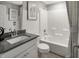Well-lit bathroom featuring subway tile, a shower-tub combo, and a modern vanity at 7644 Allesley Dr, Avon, IN 46123