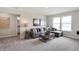 Bright and inviting living room featuring a comfortable gray sectional sofa and neutral decor at 7644 Allesley Dr, Avon, IN 46123