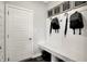 Bright mudroom featuring white board and batten, storage bench, and convenient access to the home at 7644 Allesley Dr, Avon, IN 46123