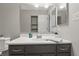 Bathroom featuring gray vanity with white countertop and large mirror at 7940 Sunfield Ct, Indianapolis, IN 46214