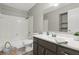 Bathroom with a shower-tub combo, gray vanity, and white countertops at 7940 Sunfield Ct, Indianapolis, IN 46214