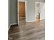 Spacious bedroom with wood-look flooring and open doorways at 7940 Sunfield Ct, Indianapolis, IN 46214