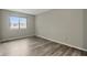 Bright bedroom featuring wood-look flooring and a large window with natural light at 7940 Sunfield Ct, Indianapolis, IN 46214