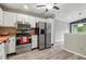 Kitchen with stainless steel appliances and light wood-look flooring at 7940 Sunfield Ct, Indianapolis, IN 46214