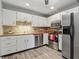 Modern kitchen featuring stainless steel appliances and white cabinetry at 7940 Sunfield Ct, Indianapolis, IN 46214