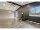 Spacious living room with vaulted ceilings, fan, and large windows at 7940 Sunfield Ct, Indianapolis, IN 46214