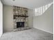 Spacious living room featuring neutral walls, carpet flooring, stairs, and a stone fireplace at 7940 Sunfield Ct, Indianapolis, IN 46214