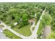 Aerial view displaying the house, spacious lawn, surrounding trees, and the tranquil neighborhood at 800 E 104Th St, Carmel, IN 46280