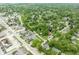 Aerial shot of the home set amongst mature trees and a quaint neighborhood, with a commercial district nearby at 800 E 104Th St, Carmel, IN 46280