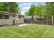 Well-maintained backyard with green grass, a patio, and a hammock at 800 E 104Th St, Carmel, IN 46280