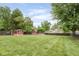Expansive backyard with manicured lawn, privacy fence, and two storage sheds, ideal for outdoor activities at 800 E 104Th St, Carmel, IN 46280