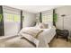 Cozy bedroom with neutral tones, two bright windows, and plush bedding at 800 E 104Th St, Carmel, IN 46280