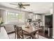 Bright dining room featuring a ceiling fan, large window and view of the backyard at 800 E 104Th St, Carmel, IN 46280