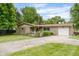Ranch-style home with attached garage and landscaped front yard at 800 E 104Th St, Carmel, IN 46280