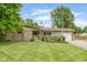 Charming ranch home featuring a well-manicured lawn and an attached garage at 800 E 104Th St, Carmel, IN 46280