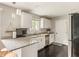 Bright kitchen features granite counters, stainless appliances, and dark hardwood floors at 800 E 104Th St, Carmel, IN 46280