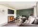 Inviting living room featuring dark wood floors, a modern sofa, and a decorative accent wall at 800 E 104Th St, Carmel, IN 46280