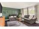 Comfortable living room with two sofas, an area rug, and a window overlooking a quiet street at 800 E 104Th St, Carmel, IN 46280