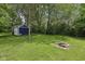 Spacious backyard featuring a storage shed and inviting fire pit area, perfect for outdoor enjoyment at 8241 Holmard Pl, Indianapolis, IN 46259