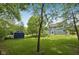 Scenic backyard view showcasing a lush lawn, storage shed, and the rear exterior of the home at 8241 Holmard Pl, Indianapolis, IN 46259